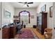 Bright home office with hardwood floors, built-in shelving, desk and comfortable seating at 2375 Fairskies Dr, Spring Hill, FL 34606