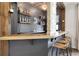 Stylish bar area with custom shelving, stone accents, and comfortable seating at 2596 Whittler Br, Odessa, FL 33556