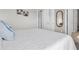 Minimalist bedroom with white bedding, neutral walls, and modern mirror at 2596 Whittler Br, Odessa, FL 33556