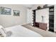 Bedroom with a mounted wooden bookcase, neutral walls, and a white bedspread at 2596 Whittler Br, Odessa, FL 33556