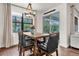 Comfortable dining area features hardwood floors, stylish lighting, and access to a patio at 2596 Whittler Br, Odessa, FL 33556