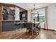 Open dining area and wet bar with stylish lighting and hardwood flooring at 2596 Whittler Br, Odessa, FL 33556