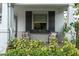 Inviting front porch with seating, window box, shutters, and decorative pillows at 2596 Whittler Br, Odessa, FL 33556
