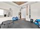 Home gym featuring rubber flooring, workout equipment, and natural light from a nearby window at 2596 Whittler Br, Odessa, FL 33556