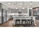 Stylish kitchen featuring a large island, stainless steel appliances, and gray cabinetry at 2596 Whittler Br, Odessa, FL 33556