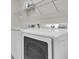 Laundry room with white appliances and storage shelves at 2596 Whittler Br, Odessa, FL 33556