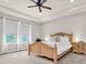 Main bedroom featuring a tray ceiling, a ceiling fan, neutral paint, and natural light at 2596 Whittler Br, Odessa, FL 33556