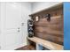 Mudroom features built-in bench, hooks, and golf equipment storage at 2596 Whittler Br, Odessa, FL 33556