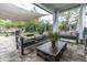 Outdoor patio seating area with shade and lush greenery in background at 2596 Whittler Br, Odessa, FL 33556