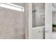 Shower featuring gray tiling, a handheld shower head, and natural light at 2596 Whittler Br, Odessa, FL 33556