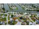 An aerial view reveals a waterfront house with boat parking, situated near winding canals and waterways at 2620 Baltic Pl, Holiday, FL 34691