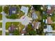An aerial view shows the home in a cul-de-sac, surrounded by a tranquil neighborhood near waterfront canals at 2620 Baltic Pl, Holiday, FL 34691