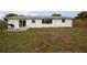Backyard featuring a patio area, perfect for outdoor entertaining, and a spacious lawn at 2620 Baltic Pl, Holiday, FL 34691