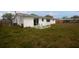 Spacious backyard with a patio, seating area, and green lawn at 2620 Baltic Pl, Holiday, FL 34691