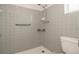 Bathroom showcasing a shower stall with tile surround and a grab bar for accessibility at 2620 Baltic Pl, Holiday, FL 34691