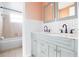 Bathroom features double sinks, a vanity with decorative knobs, and tiled walls at 2620 Baltic Pl, Holiday, FL 34691