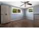Bedroom features hardwood floors, a ceiling fan, and large windows with natural light at 2620 Baltic Pl, Holiday, FL 34691
