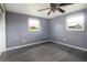 Bedroom offers ample natural light from two windows and stylish laminate flooring at 2620 Baltic Pl, Holiday, FL 34691