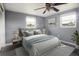 Cozy bedroom featuring a comfortable bed, soft lighting, modern ceiling fan and two windows at 2620 Baltic Pl, Holiday, FL 34691