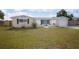 Charming single-story home featuring a well-manicured lawn and a welcoming front entrance with decorative concrete fencing at 2620 Baltic Pl, Holiday, FL 34691