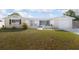 Charming single-story home featuring a well-manicured lawn and a welcoming front entrance with decorative concrete fencing at 2620 Baltic Pl, Holiday, FL 34691