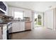 Updated kitchen with white cabinets, stainless steel appliances, granite countertops, and tile flooring at 2620 Baltic Pl, Holiday, FL 34691