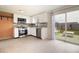 Modern kitchen boasts stainless steel appliances, stylish backsplash, and sliding glass doors leading to the backyard at 2620 Baltic Pl, Holiday, FL 34691