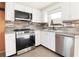 Modern kitchen featuring stainless steel appliances, sleek countertops, and a stylish backsplash at 2620 Baltic Pl, Holiday, FL 34691