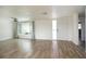 Bright living room with wood-look floors, ceiling fan, and large window allowing ample natural light at 2620 Baltic Pl, Holiday, FL 34691