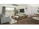 Inviting living room with modern furnishings, wood-look floors, neutral colors and large windows at 2620 Baltic Pl, Holiday, FL 34691