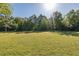 Lush backyard, surrounded by mature trees, offers a peaceful retreat at 2628 Shipston Ave, New Port Richey, FL 34655
