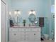 Modern bathroom with double sinks, granite countertops, with a view from the arched window at 2628 Shipston Ave, New Port Richey, FL 34655