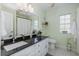 Bathroom featuring granite countertops, white cabinets and decorative tiling at 2628 Shipston Ave, New Port Richey, FL 34655