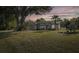 Beautiful home with manicured lawn, lush landscaping, and covered front entry at 2628 Shipston Ave, New Port Richey, FL 34655