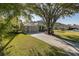 Well-maintained home featuring a two-car garage, driveway, and mature shade tree at 2628 Shipston Ave, New Port Richey, FL 34655