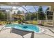 Beautifully screened pool with a spacious patio area and lush surroundings at 2628 Shipston Ave, New Port Richey, FL 34655