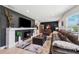 Cozy living room features a fireplace, stylish decor, and comfortable leather furniture at 319 S Glen Arven Ave, Temple Terrace, FL 33617