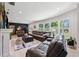 Spacious living room with a fireplace, hardwood floors, and comfortable leather furniture at 319 S Glen Arven Ave, Temple Terrace, FL 33617