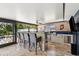Enjoy outdoor cooking in this screened in patio with a built-in bar, grill, granite countertops, and a tv for entertainment at 319 S Glen Arven Ave, Temple Terrace, FL 33617
