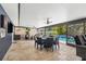 This fully screened patio offers versatile seating, a view of the pool, a wet bar, and tile flooring for easy maintenance at 319 S Glen Arven Ave, Temple Terrace, FL 33617