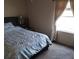 This bedroom features a bed, a side table, and a window with sheer curtains at 34135 Brown Bayou, Wesley Chapel, FL 33543