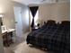 Spacious bedroom features neutral walls, a window, and a patterned bedspread at 34135 Brown Bayou, Wesley Chapel, FL 33543