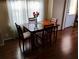 Dining room features a wood table set for four, illuminated by natural light at 34135 Brown Bayou, Wesley Chapel, FL 33543