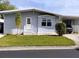 Charming single-story home with light blue siding, well-manicured lawn and covered carport at 34135 Brown Bayou, Wesley Chapel, FL 33543