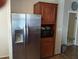 A stainless steel refrigerator and dark cabinets at 34135 Brown Bayou, Wesley Chapel, FL 33543