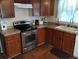 Modern kitchen with stainless steel oven and dark wood cabinets at 34135 Brown Bayou, Wesley Chapel, FL 33543