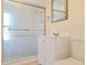 Bathroom featuring a glass shower, white vanity, mirror, and a neutral color palette at 3622 Cheswick Dr, Holiday, FL 34691