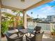Back patio with four-seat table, and a view of a canal lined with neighboring properties at 4058 Centavo Ct, Hernando Beach, FL 34607
