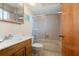 Bathroom featuring a tub with sliding glass doors and wooden vanity at 4058 Centavo Ct, Hernando Beach, FL 34607