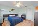 Cozy bedroom with a ceiling fan, a large bed, and a view of the outdoors at 4058 Centavo Ct, Hernando Beach, FL 34607